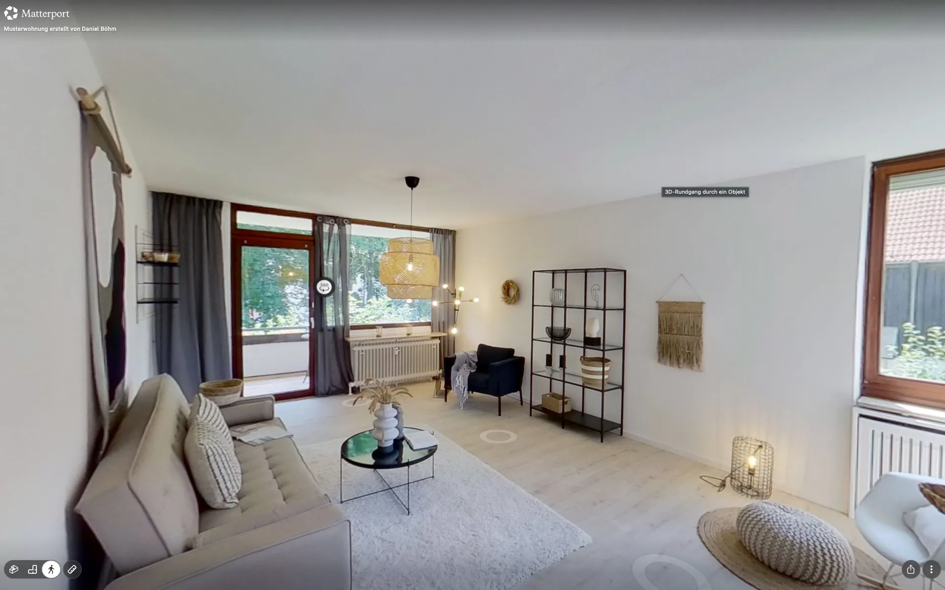 Blick in einen 3D-Rundgang: Wohnzimmer mit Sofa und Balkontür